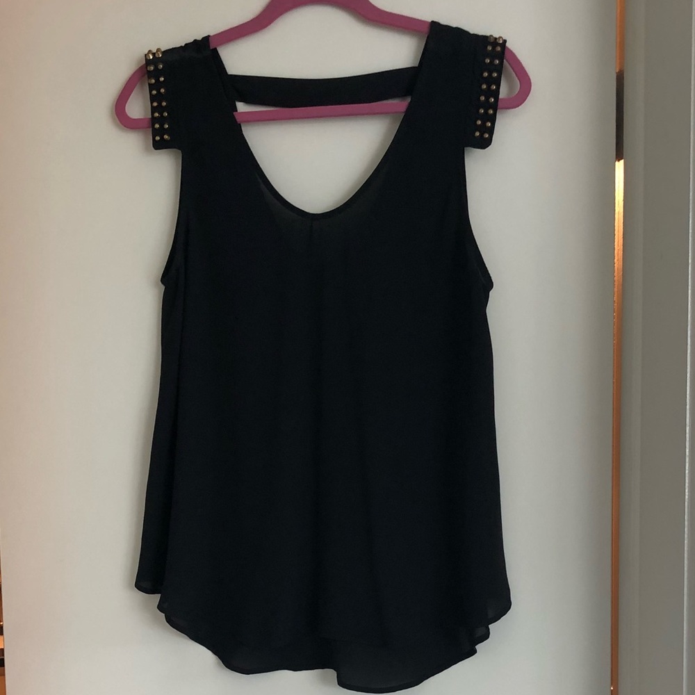 Black top with gold stuffed shoulders.